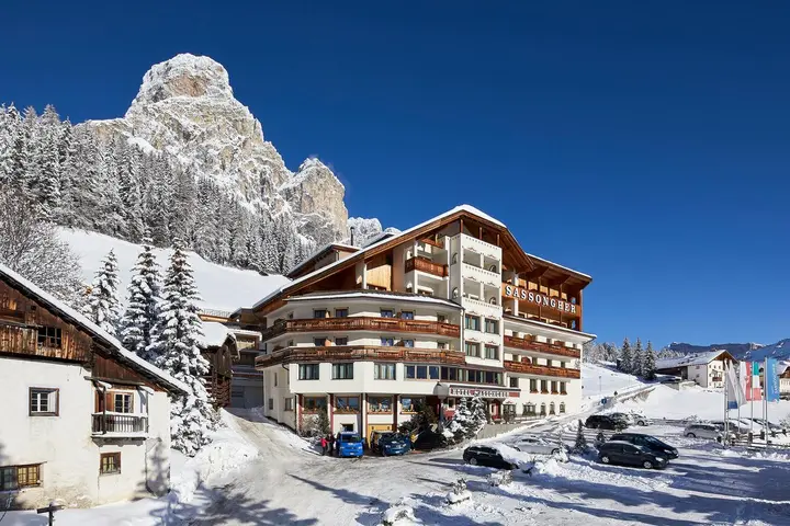 Hotel Sassongher in Corvara, Alta Badia, its timber facade under snow