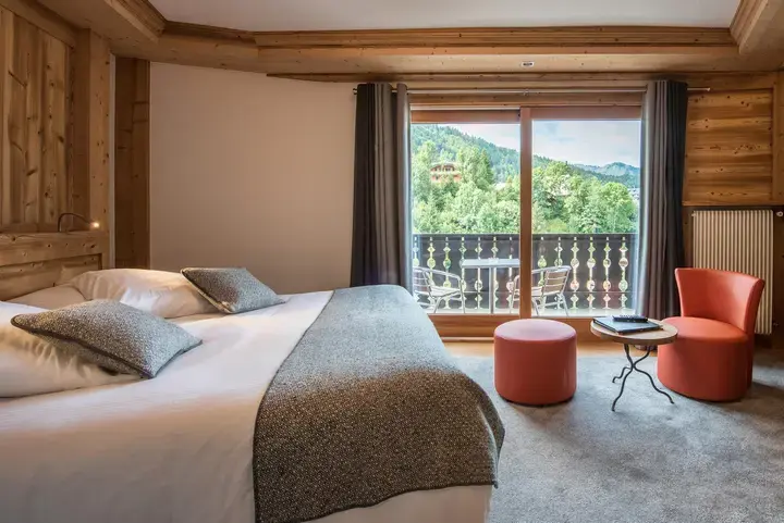 Family room at Hotel Le Petit Dru in Morzine, with twin beds and a balcony