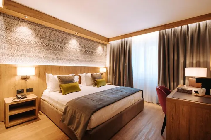 Double room at Valtur Cervinia Cristallo, with wood panelling and a large window